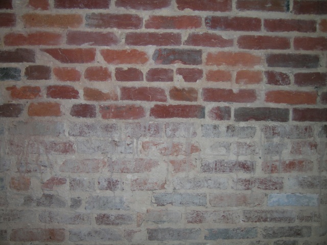 This wall has been halfway cleaned with a power washer This wall has been halfway cleaned with a power washer