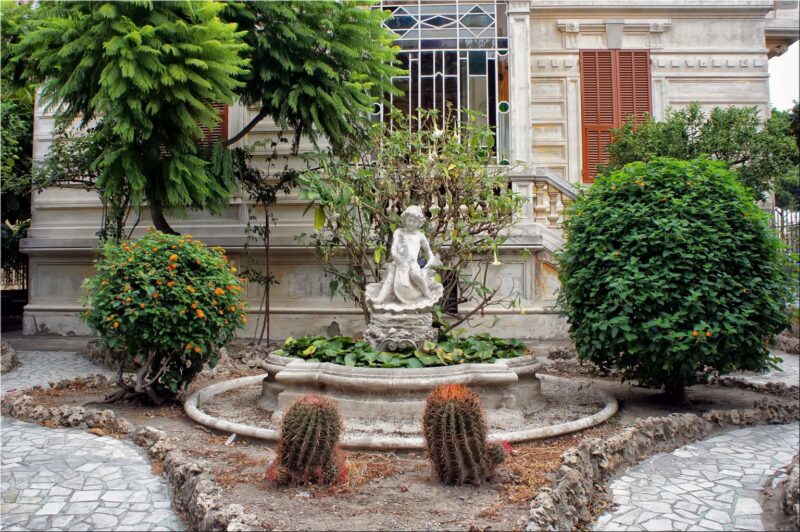 A formal statuary garden blends well with the architectural style of this house A formal statuary garden blends well with the architectural style of this house